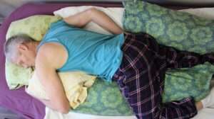 Adjustable handmade millet body pillow filled with organic hulls, covered in thick 100% organic cotton sateen, perfect for side, back, and belly sleepers.