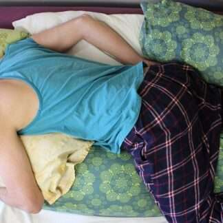 Adjustable handmade millet body pillow filled with organic hulls, covered in thick 100% organic cotton sateen, perfect for side, back, and belly sleepers.