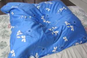 Handcrafted organic millet pillow with soft 100% organic cotton cover and premium zippered case, filled with US-grown chemical-free millet hulls for gentle, quiet, and supportive sleep comfort.