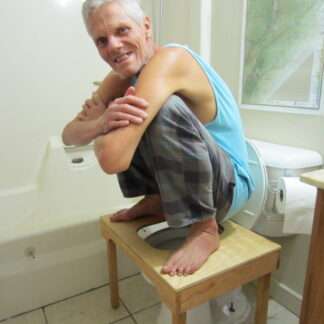 Brett demonstrating the full squat toilet stool on squatting toilet platform for natural elimination.