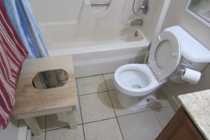 Squatting toilet platform positioned away from the toilet.