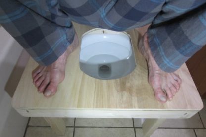 Squatting toilet platform with the feet at a proper distance apart. Full squat over toilet bowl!