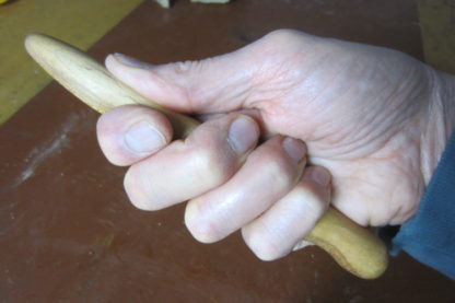 Hand carved massage stick fits perfectly in your hand with spots for each finger and thumb. Nice.