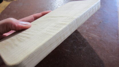 Handheld massage tool has four different edges. Made of solid wood.