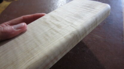 Handheld massage tool has four different edges. Made of solid wood.