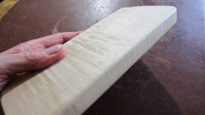 Handheld massage tool has four different edges. Made of solid wood.