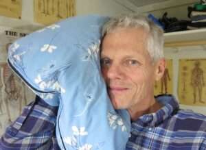 Organic millet hull pillow with breathable cotton cover providing gentle, adjustable support.