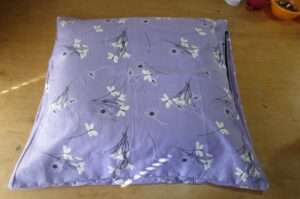 Handcrafted organic millet pillow with soft 100% organic cotton cover and premium zippered case, filled with US-grown chemical-free millet hulls for gentle, quiet, and supportive sleep comfort.